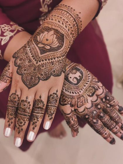 A stunning design combining two auspicious motifs: the lotus and the elephant. The back of the hands feature these central elements surrounded by intricate patterns, perfect for a wedding guest.