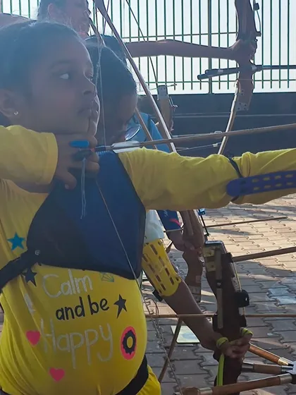 "Calm and be Happy." This young archer's shirt says it all. We teach our students to find joy and focus in their practice.