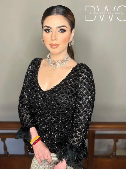 Another portrait of the client, showcasing how a sleek ponytail can highlight facial features and statement jewelry.