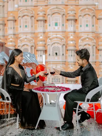 A celebratory toast with the Hawa Mahal as your witness. This rooftop setup is perfect for a romantic and private pre-wedding moment, away from the crowds.