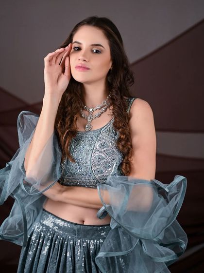 A close-up shot highlighting the intricate silver embroidery on the blouse of this grey ombre lehenga. These are the details that make a professional shoot stand out.