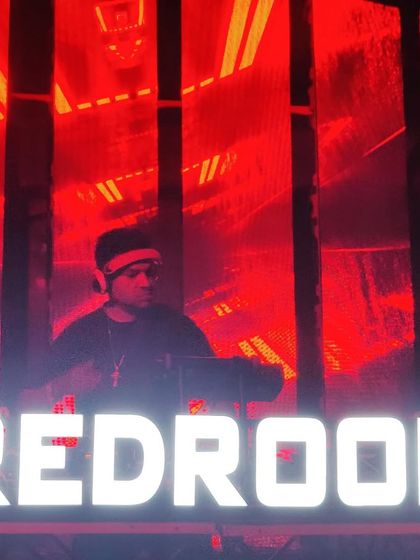 Surrounded by the signature red glow of a Redroom party. The intensity of the color matches the intensity of the music.