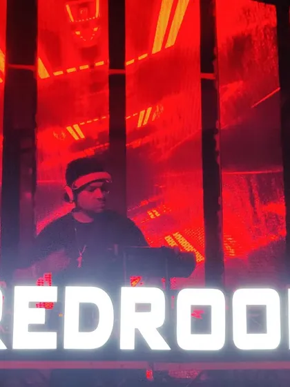 Surrounded by the signature red glow of a Redroom party. The intensity of the color matches the intensity of the music.
