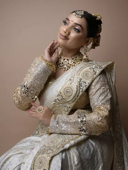 A beautiful shot of a student's final exam work. This elegant Peshwai look features a clean, traditional hairstyle and soft, glowing makeup.