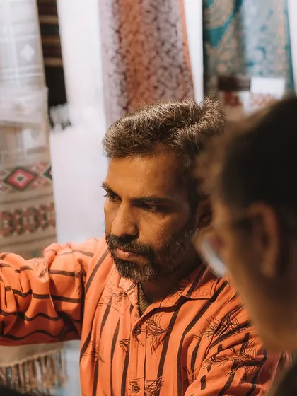 A shopkeeper explaining his wares to customers. I used a tight frame to capture the intensity and detail of the interaction in the bustling market.