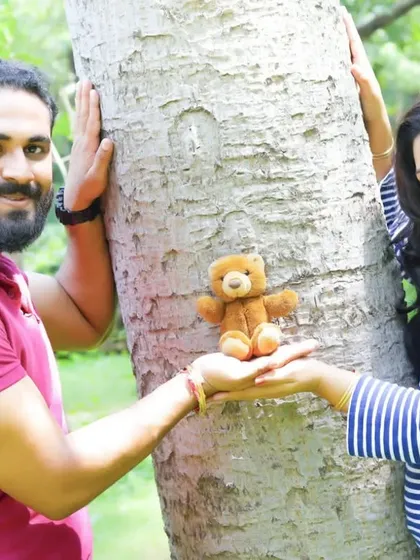 A fun and creative maternity photo with a teddy bear. We love when couples bring props that are meaningful to them for their pregnancy photoshoot.