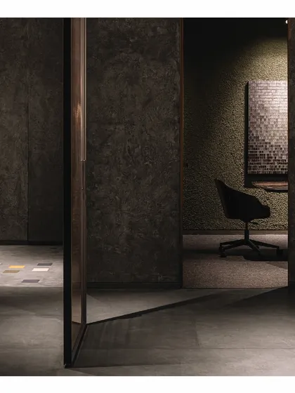 A quiet workroom within the 'Frozen' retail space, demonstrating how the moody, textural design can also create focused, private areas. The shadows and simple forms maintain the project's overall Zen aesthetic.