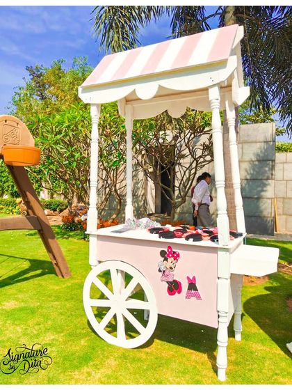 A close-up of the adorable Minnie Mouse-themed cart, used for distributing party favours or serving small treats.