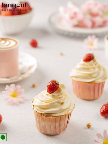 A soft, delicate cupcake filled with a surprise center of fresh strawberry compote. Topped with a swirl of cream and a fresh berry, it's the perfect little treat.