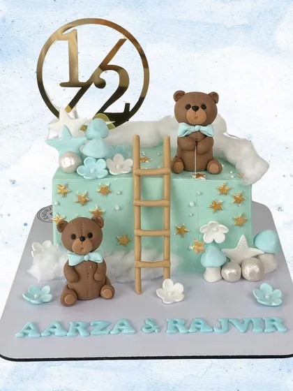 Celebrating a half-birthday for Aarza & Rajvir! This adorable cake features two teddy bears, a ladder to the stars, and a "1/2" topper.