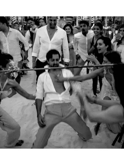 A game of beach limbo at Shaza and Priyaank's wedding in the Maldives. This black and white shot focuses on the action and fun, capturing the carefree spirit of a destination wedding party.