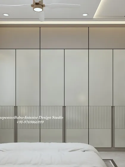 A close-up of the wardrobe, showing the two-tone design and subtle fluted detailing on the lower panels. It's a great example of minimalist design with a touch of texture.