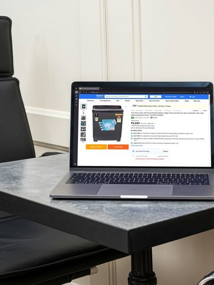 A clear view of a washing machine listing on the laptop screen, proving our capability in handling large appliance photography.