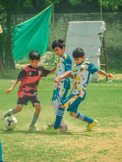 Multiple players challenge for the ball in a crowded area, a testament to the game's intensity.