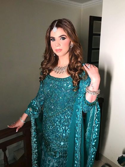 A portrait of the client, her soft curls and maang tikka creating a beautiful, traditional look for a wedding function.