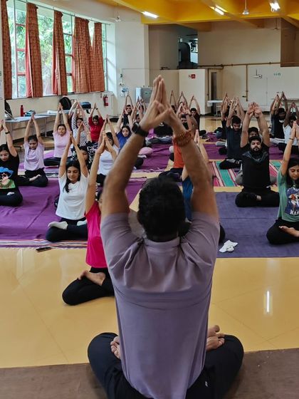 Leading a large group of MBA students in a meditation and yoga session. Introducing mindfulness early in a professional's journey is key to long-term success and well-being.
