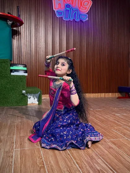 This student shows off her dandiya pose in a lovely blue and pink traditional dress. Our classes focus on both individual expression and group choreography.