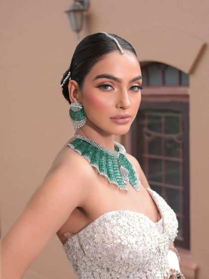 A beautiful portrait of the dainty bride. Her makeup is minimal yet impactful, with a flawless base and softly defined features.