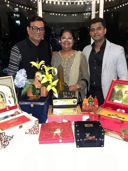 I am incredibly proud to be recognized for my work, pictured here with my International Iconic Award. This photo showcases a selection of my bespoke boxed invitations, representing the dedication and craftsmanship I pour into every client project.