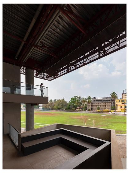 An interstitial event space is created on the terrace of the old building, underneath the new "Hoverspace" extension. This semi-enclosed area provides a place for gatherings with views of the adjacent sports ground.