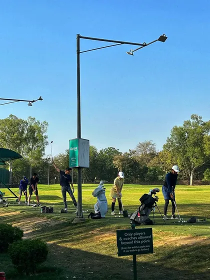A busy practice area with our sign reminding players that this is a dedicated space for golfers and coaches.