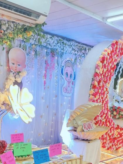 A 'Boss Baby' themed baby shower decoration, combining cartoon fun with elegant floral elements like a flower-covered moon cradle. This shows how I can merge different styles to create a unique look.