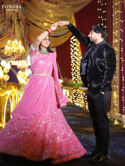 Dancing the night away. This couple looks amazing, with him in a sleek all-black suit with a velvet blazer, a modern and stylish choice for any evening celebration.