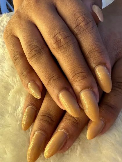 Another view of the beautiful nude shimmer nails, showing off their almond shape and delicate sparkle.