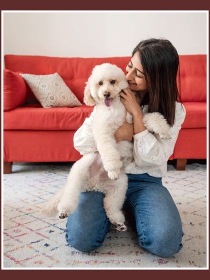 Dinkan gets a loving cuddle from his mom. This photo highlights the affection and comfort pets bring into our homes.