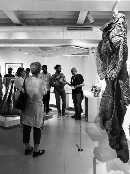 A black and white photo of a guided walk through the Museum of Art and Photography (MAP). We believe that architecture should facilitate connection and conversation, and it's rewarding to see the space being used for learning and community engagement.