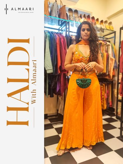 This is your perfect Haldi outfit. A vibrant marigold yellow jumpsuit with palazzo pants is both comfortable and incredibly chic. Paired with a statement green clutch, it’s a modern look that stands out.