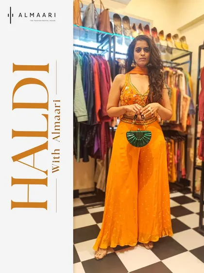 Bright, bold, and ready for a Haldi ceremony. This vibrant orange sharara set is both comfortable and stylish, paired here with a contrasting green clutch for a fun pop of color. I styled this look right here in our Bandra store.