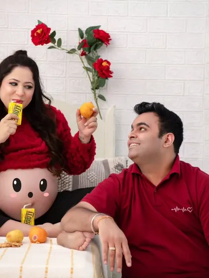 The joy of sharing treats. This shot captures the mother-to-be enjoying her mango drink while the father-to-be looks on with a smile. It's a sweet, candid moment.