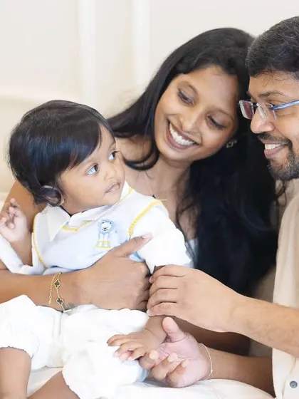 A tender moment between parents and their baby during his first birthday shoot. The studio's soft lighting is perfect for capturing these gentle, intimate family connections.