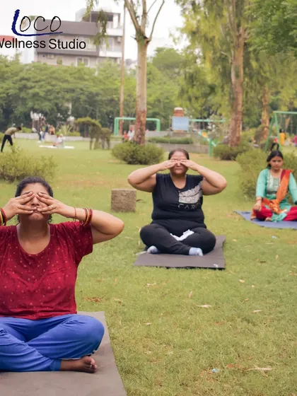 More members finding their center with a calming breathing exercise at our outdoor yoga event. Taking our practice outside adds a new dimension of peace and connection.