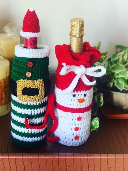 This pair of bottle covers features an elf and a snowman design. The snowman cover has a cute drawstring top that looks like a sack.