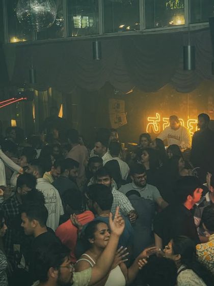 The red laser beams add a dramatic flair to the party at Sarjapur Social.