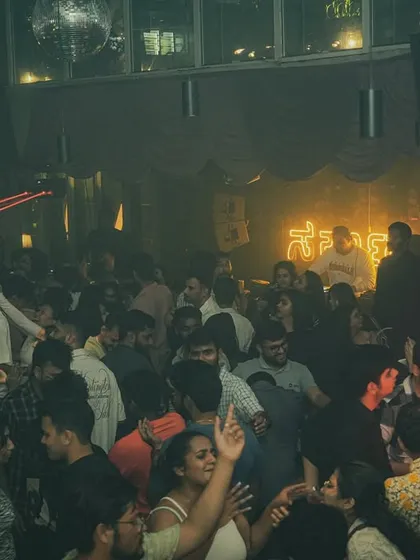 The red laser beams add a dramatic flair to the party at Sarjapur Social.
