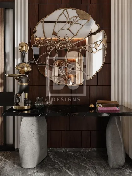 A detail shot of the console table in the Dadar project. The combination of a stone base, black marble top, and sculptural mirror creates a stunning and artistic focal point.