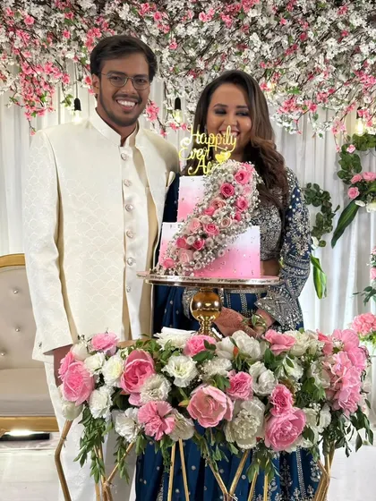 The happy couple posing with their fresh floral wedding cake. It's always a joy to see my creations as part of such a beautiful moment.