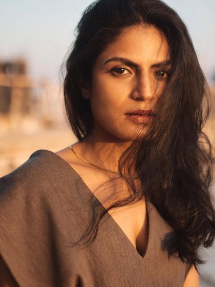 A beautiful close-up where the wind adds natural movement to the hair. The soft, warm light is incredibly flattering.