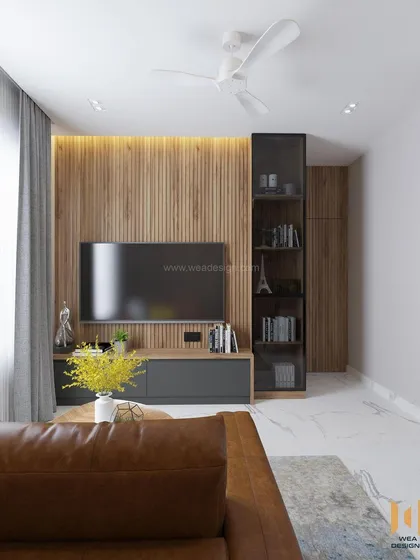 A view of the TV unit in the multifunctional room, with a sleek grey console and a glass-fronted bookshelf.