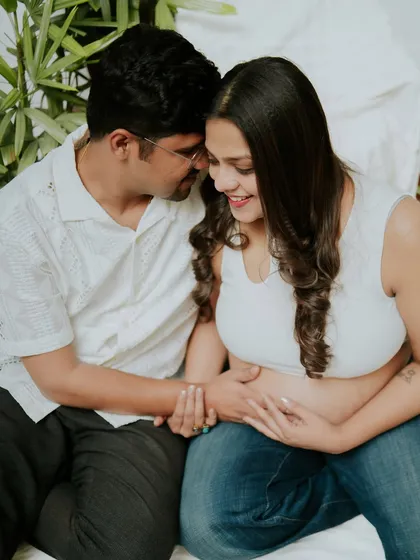 An intimate and candid moment between a couple during their at-home lifestyle maternity session. These unposed shots are full of genuine emotion.