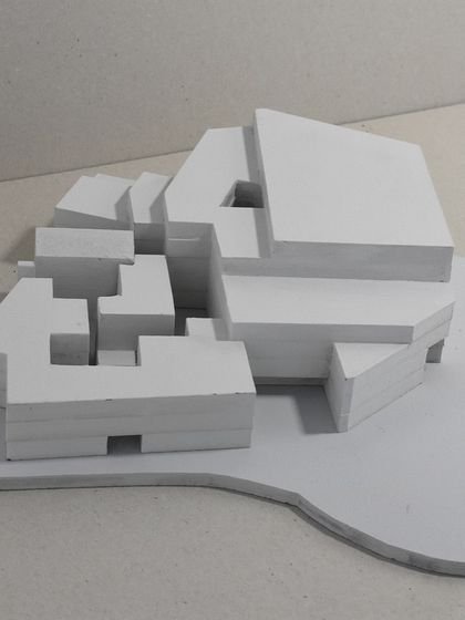 A handmade architectural model in white, showing the initial massing and form-finding stage of our design process. This is where we test ideas and explore spatial relationships.