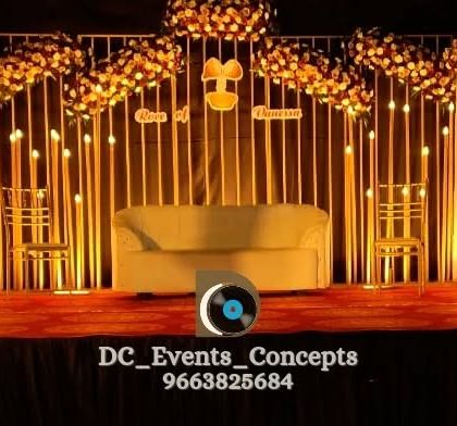 A warm and inviting Roce decor setup with a slatted wooden backdrop, elegant floral arrangements, and soft overhead lighting.