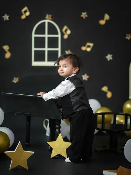 A sweet glance back at the camera while exploring the mini grand piano. We capture your child's natural movements and curiosity.