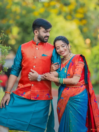 A sweet and relaxed portrait of the couple. Her hand on his arm and his lean create a comfortable and affectionate pose.