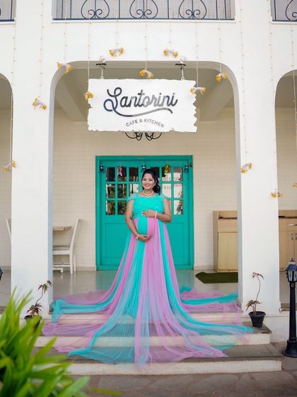 A full-length view of the dual-color pink and blue trail gown. The long, colorful train looks amazing cascading down the steps.