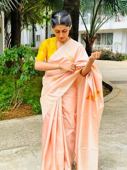 A full-length view of my peach and yellow saree combination. It's a fresh and bright look, perfect for a daytime event.