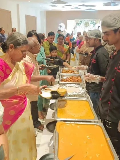 We believe in attentive service for all your guests. Here, one of our staff members assists a guest at a wedding anniversary celebration, ensuring everyone feels welcomed and cared for.
